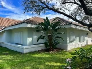 White accordion shutters closed across openings on a Florida home