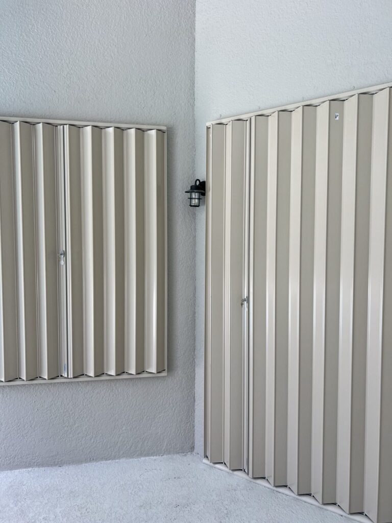 Close view of accordion shutters over windows and a door