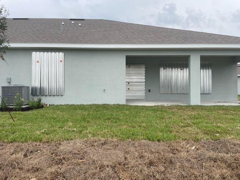 24-gauge galvanized steel storm panels installed across rear home openings